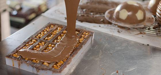 Chocolate and nuts being processed in a Swiss confiserie.